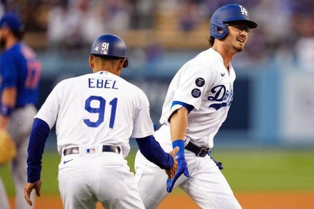 Zach McKinstry of the Los Angeles Dodgers celebrates with Dino Ebel after hitting a home run during the game between the Chicago Cubs and the Los...