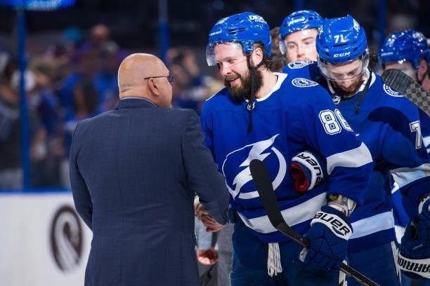 Nikita Kucherov of the Tampa Bay Lightning shakes hands with Head Coach Barry Trotz of the New York Islanders after the series win in Game Seven of...
