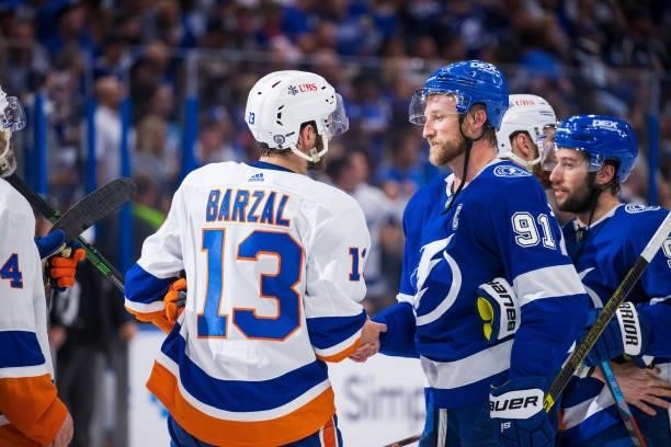 Steven Stamkos of the Tampa Bay Lightning shakes hands with Mathew Barzal of the New York Islanders after the series win in Game Seven of the Stanley...