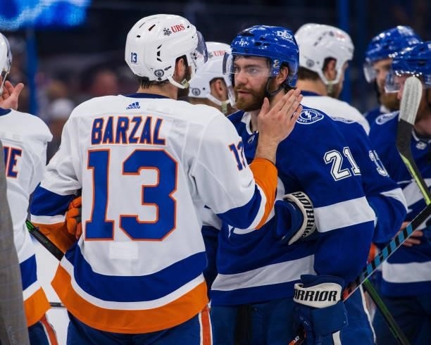 Brayden Point of the Tampa Bay Lightning shakes hands with Mathew Barzal of the New York Islanders after the series win in Game Seven of the Stanley...