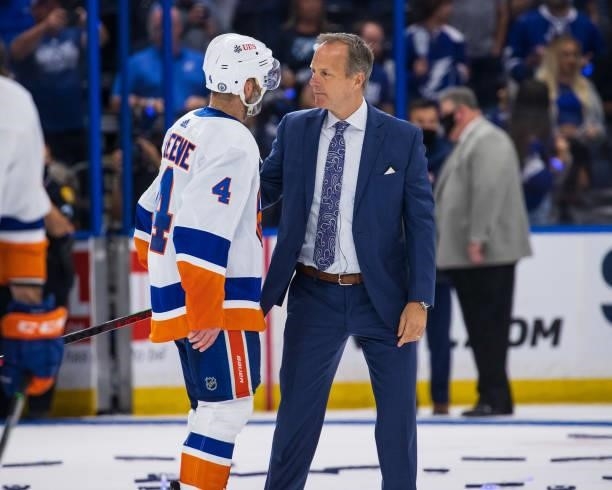 Head Coach Jon Cooper of the Tampa Bay Lightning shakes hands with Andy Greene of the New York Islanders after the series win in Game Seven of the...