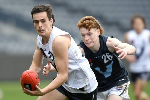 Ned Moodle of Vic Country handballs during the U17 Championships match between Vic Country and Vic Metro at GMHBA Stadium on June 26, 2021 in...