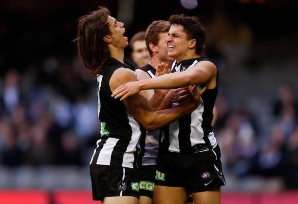 Caleb Poulter and Trent Bianco of the Magpies celebrate during the 2021 AFL Round 15 match between the Collingwood Magpies and the Fremantle Dockers...