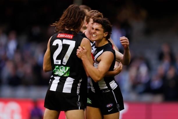 Caleb Poulter and Trent Bianco of the Magpies celebrate during the 2021 AFL Round 15 match between the Collingwood Magpies and the Fremantle Dockers...