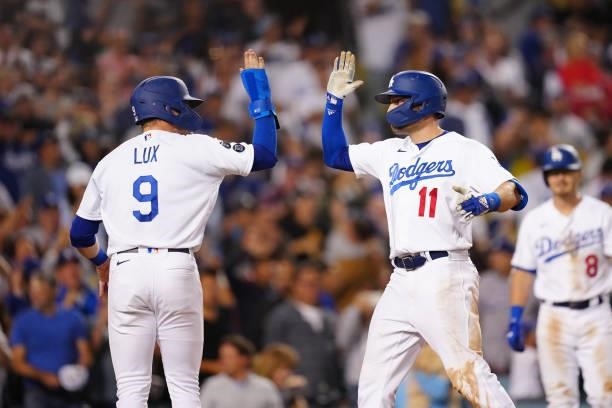 Gavin Lux of the Los Angeles Dodgers celebrates with AJ Pollock after Pollock hit a home run during the game between the Chicago Cubs and the Los...