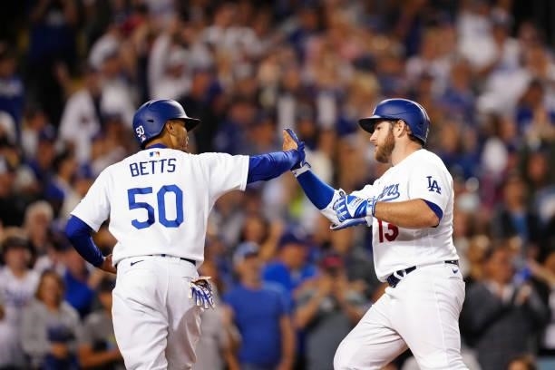 Max Muncy of the Los Angeles Dodgers celebrates with Mookie Betts after hitting a home run during the game between the Chicago Cubs and the Los...