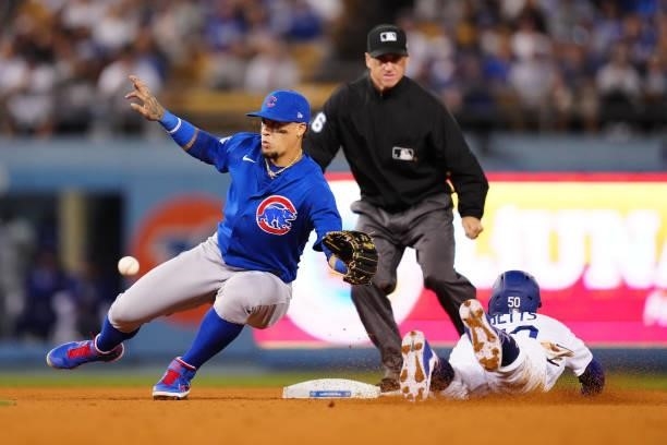 Javier Báez of the Chicago Cubs looks for the ball as Mookie Betts of the Los Angeles Dodgers steals second during the game between the Chicago Cubs...