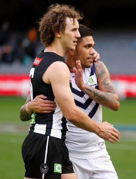 Chris Mayne of the Magpies and Michael Walters of the Dockers embrace after the 2021 AFL Round 15 match between the Collingwood Magpies and the...