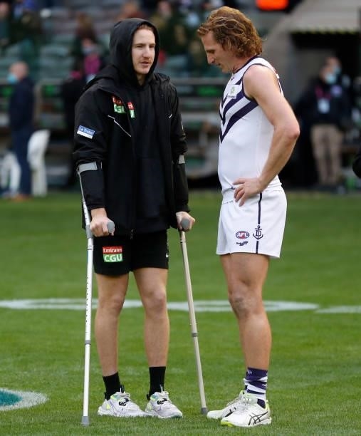 Beau McCreery of the Magpies and David Mundy of the Dockers chat after the 2021 AFL Round 15 match between the Collingwood Magpies and the Fremantle...