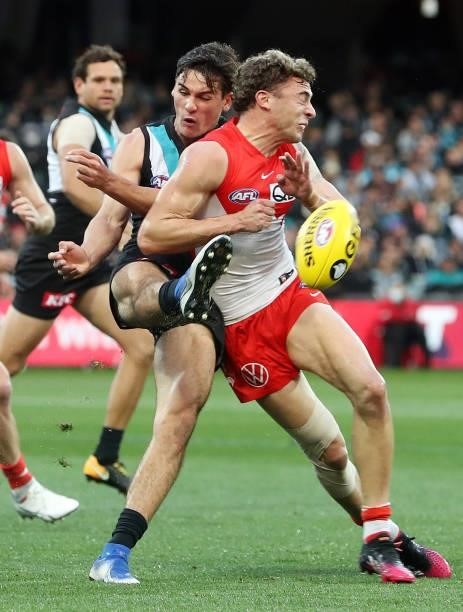 Connor Rozee of the Power and Will Hayward of the Swans during the 2021 AFL Round 15 match between the Port Adelaide Power and the Sydney Swans at...