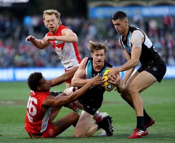 Joel Amartey of the Swans tackles Tom Jonas of the Power during the 2021 AFL Round 15 match between the Port Adelaide Power and the Sydney Swans at...