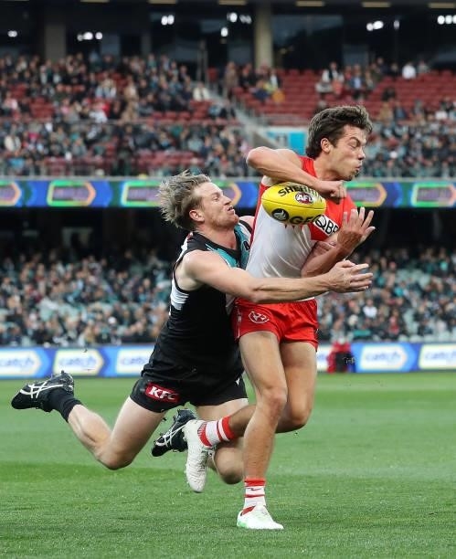 Oliver Florent of the Swans and Tom Jonas of the Power during the 2021 AFL Round 15 match between the Port Adelaide Power and the Sydney Swans at...