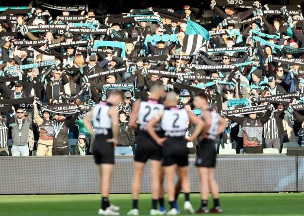 Port Fans stand for Never Tear Us Apart during the 2021 AFL Round 15 match between the Port Adelaide Power and the Sydney Swans at Adelaide Oval on...