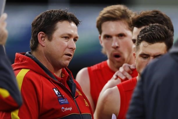 Stuart Dew, Senior Coach of the Suns addresses his players during the 2021 AFL Round 15 match between the North Melbourne Kangaroos and the Gold...