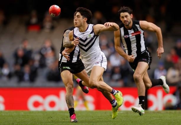 Adam Cerra of the Dockers and Jamie Elliott of the Magpies in action during the 2021 AFL Round 15 match between the Collingwood Magpies and the...