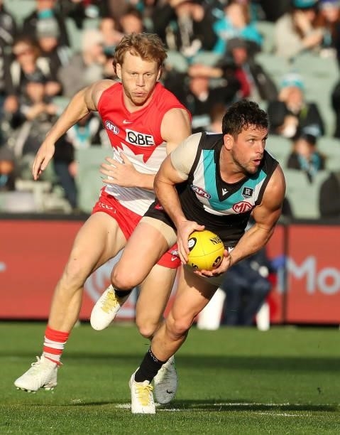 Travis Boak of the Power and Callum Mills of the Swans during the 2021 AFL Round 15 match between the Port Adelaide Power and the Sydney Swans at...