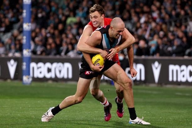 Will Hayward of the Swans tackles Jarrod Lienert of the Power during the 2021 AFL Round 15 match between the Port Adelaide Power and the Sydney Swans...