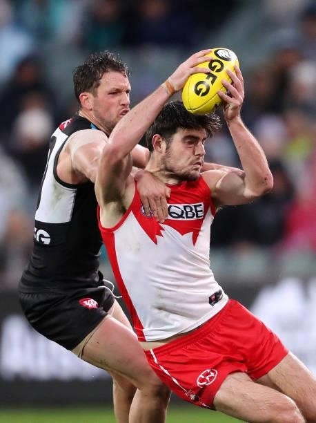 George Hewett of the Swans and Travis Boak of the Power during the 2021 AFL Round 15 match between the Port Adelaide Power and the Sydney Swans at...