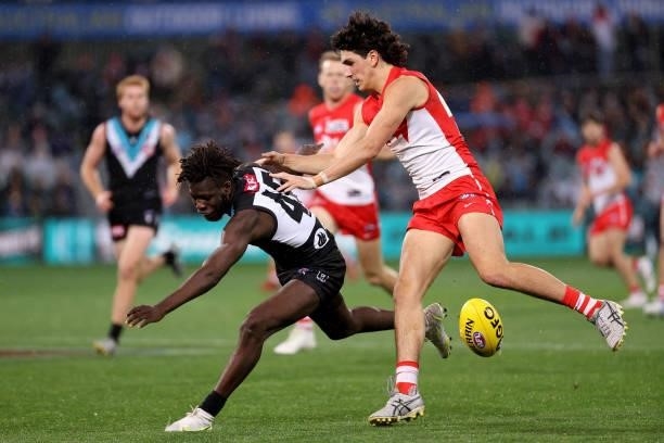 Justin McInerney of the Swans tackles Martin Frederick of the Power during the 2021 AFL Round 15 match between the Port Adelaide Power and the Sydney...