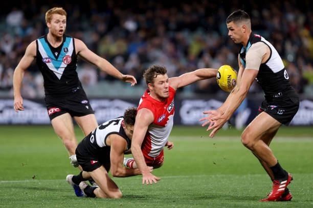 Karl Amon of the Power tackles Luke Parker of the Swans during the 2021 AFL Round 15 match between the Port Adelaide Power and the Sydney Swans at...