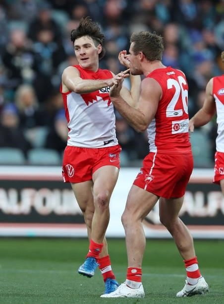 Errol Gulden of the Swans celebrates a goal with Luke Parker during the 2021 AFL Round 15 match between the Port Adelaide Power and the Sydney Swans...