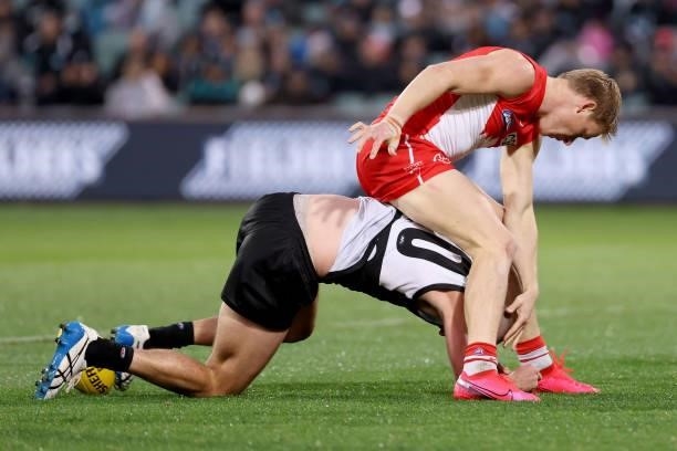 Isaac Heeney of the Swans tackles Jarrod Lienert of the Power during the 2021 AFL Round 15 match between the Port Adelaide Power and the Sydney Swans...