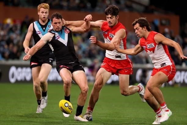 Travis Boak of the Power competes with George Hewett of the Swans during the 2021 AFL Round 15 match between the Port Adelaide Power and the Sydney...