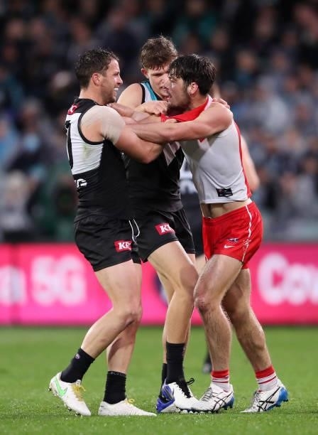 Tempers Flare between George Hewett of the Swans and Travis Boak of the Power with Mitch Georgiades of the Power during the 2021 AFL Round 15 match...