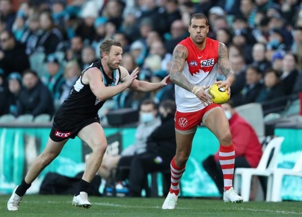 Lance Franklin of the Swans looks ahead from Trent McKenzie of Port Adelaide during the 2021 AFL Round 15 match between the Port Adelaide Power and...