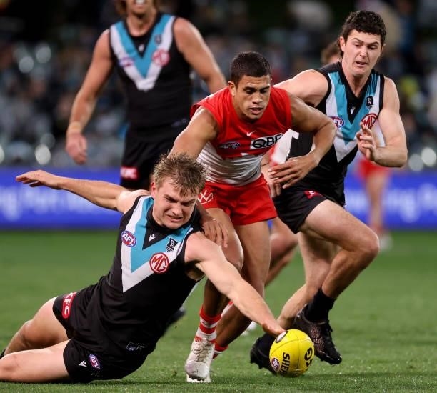 Ollie Wines of the Power is tackled by James Bell of the Swans during the 2021 AFL Round 15 match between the Port Adelaide Power and the Sydney...