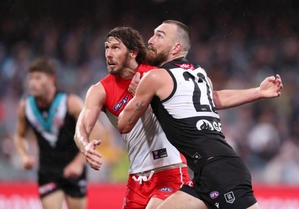 Charlie Dixon of the Power and Tom Hickey of the Swans during the 2021 AFL Round 15 match between the Port Adelaide Power and the Sydney Swans at...