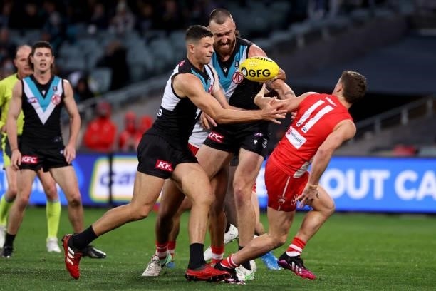 Ryan Burton of the Power competes with Tom Papley of the Swans during the 2021 AFL Round 15 match between the Port Adelaide Power and the Sydney...
