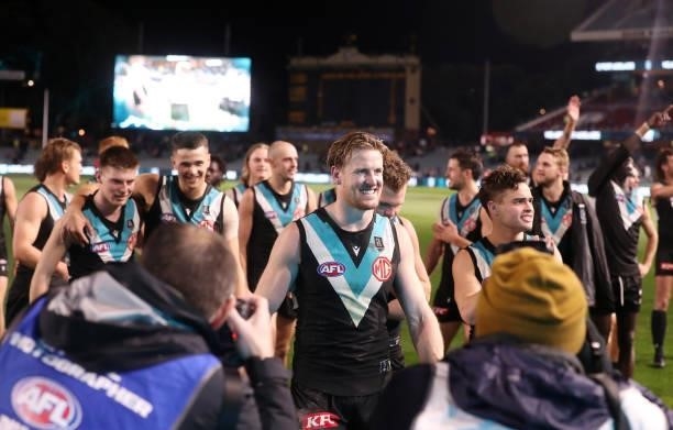 Tom Jonas of the Power leads his team off after the win during the 2021 AFL Round 15 match between the Port Adelaide Power and the Sydney Swans at...