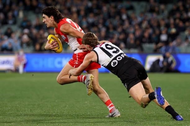 Mitch Georgiades of tackles Justin McInerney of the Swans during the 2021 AFL Round 15 match between the Port Adelaide Power and the Sydney Swans at...