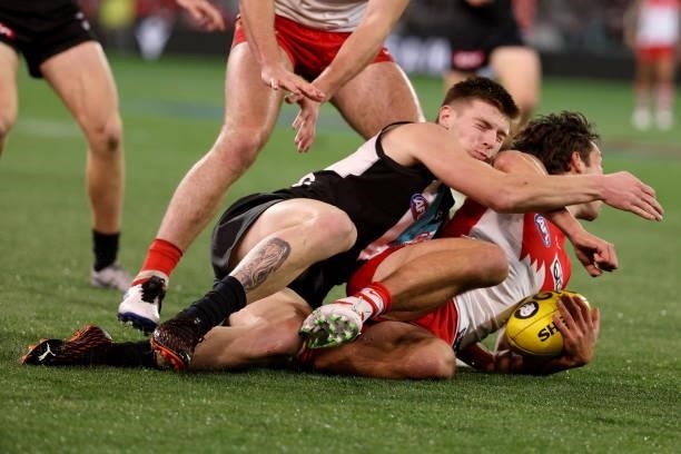 Dylan Williams of the Power tackles Oliver Florent of the Swans during the 2021 AFL Round 15 match between the Port Adelaide Power and the Sydney...
