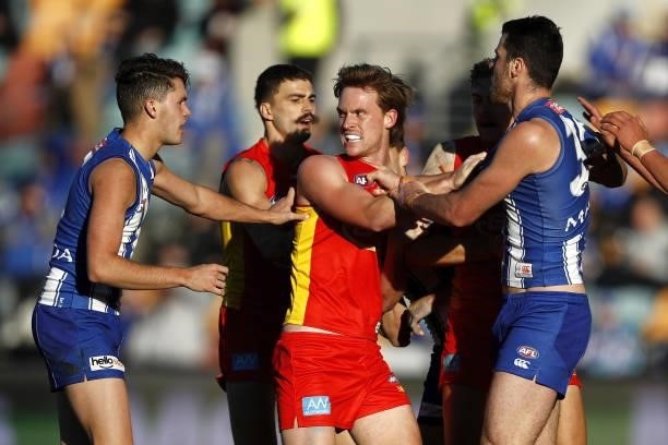 Noah Anderson of the Suns remonstrates with Curtis Taylor of the Kangaroos and Tristan Xerri of the Kangaroos during the 2021 AFL Round 15 match...