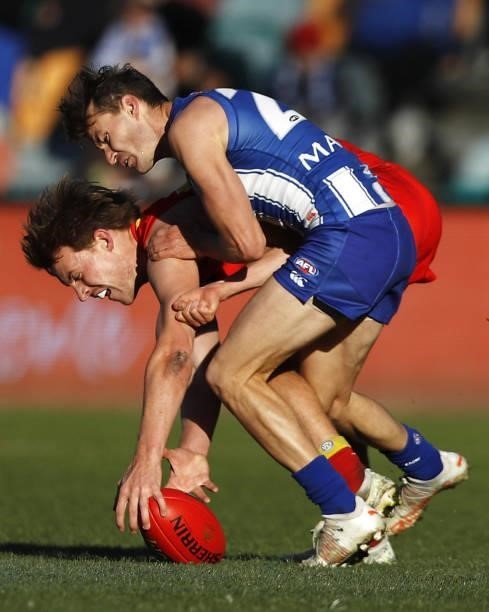 Noah Anderson of the Suns and Kayne Turner of the Kangaroos collide as they compete for the ball during the 2021 AFL Round 15 match between the North...