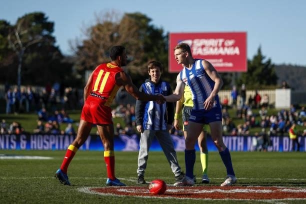 Touk Miller of the Suns and Jack Ziebell of the Kangaroos are seen at the coin toss during the 2021 AFL Round 15 match between the North Melbourne...