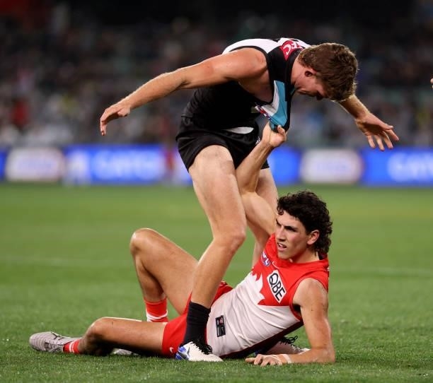 Mitch Georgiades of the Power clashes with Justin McInerney of the Swans during the 2021 AFL Round 15 match between the Port Adelaide Power and the...