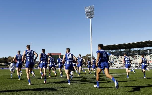 North Melbourne run on to the field during the 2021 AFL Round 15 match between the North Melbourne Kangaroos and the Gold Coast Suns at Blundstone...