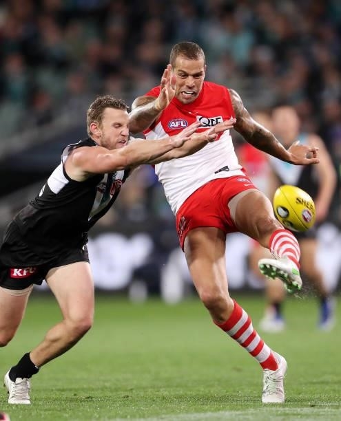Trent McKenzie of the Power tries to smother the kick of Lance Franklin of the Swans during the 2021 AFL Round 15 match between the Port Adelaide...