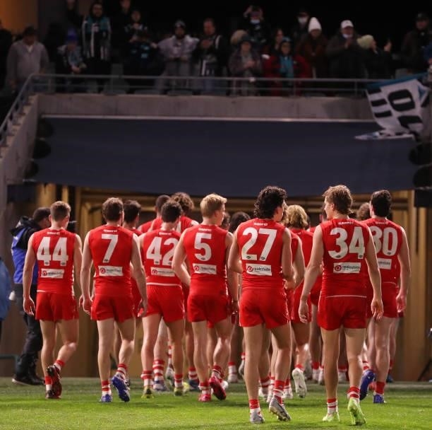 Sydney Swans players leave the oval after the loss during the 2021 AFL Round 15 match between the Port Adelaide Power and the Sydney Swans at...
