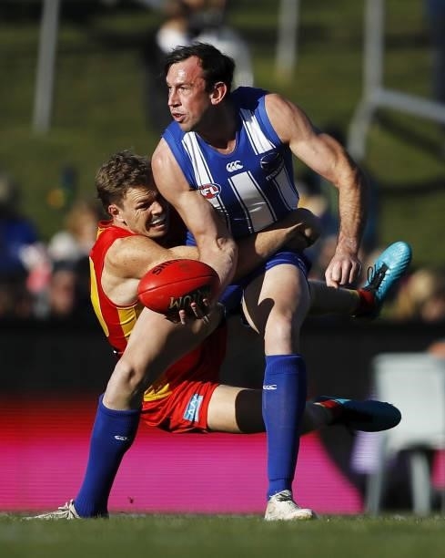 Todd Goldstein of the Kangaroos is tackled by Nick Holman of the Suns during the 2021 AFL Round 15 match between the North Melbourne Kangaroos and...
