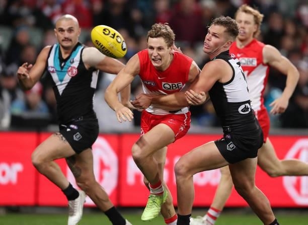 Jordan Dawson of the Swans and Dan Houston of the Power and Sam Powell-Pepper of the Power during the 2021 AFL Round 15 match between the Port...