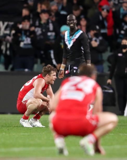 Luke Parker on his haunches along with other Sydney players after the loss during the 2021 AFL Round 15 match between the Port Adelaide Power and the...
