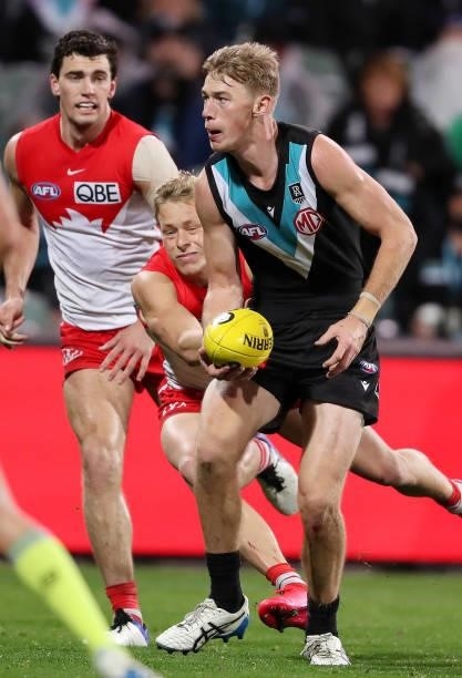 Todd Marshall of the Power and Isaac Heeney of the Swans during the 2021 AFL Round 15 match between the Port Adelaide Power and the Sydney Swans at...