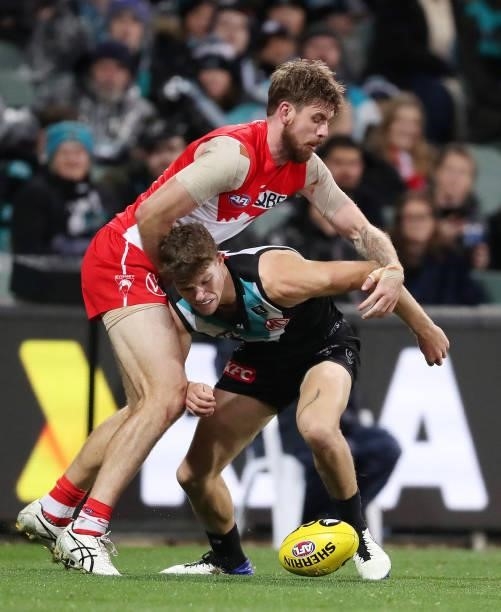 Mitch Georgiades of the Power and Kaiden Brand of the Swans during the 2021 AFL Round 15 match between the Port Adelaide Power and the Sydney Swans...