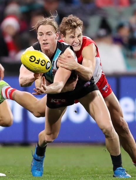 Miles Bergman of the Power and Jordan Dawson of the Swans during the 2021 AFL Round 15 match between the Port Adelaide Power and the Sydney Swans at...