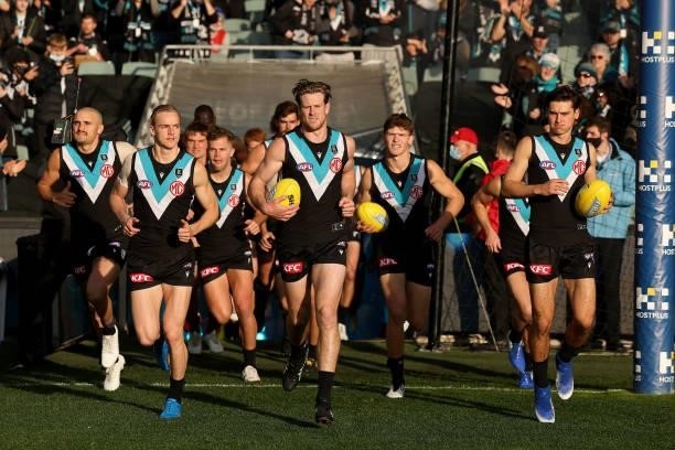 The Power run out during the 2021 AFL Round 15 match between the Port Adelaide Power and the Sydney Swans at Adelaide Oval on June 26, 2021 in...