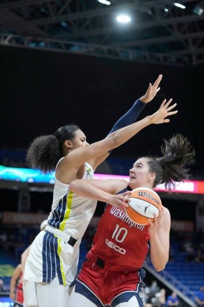 Satou Sabally of the Dallas Wings plays defense on Megan Gustafson of the Washington Mystics on June 26, 2021 at the College Park Center in...